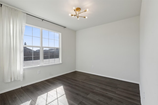 unfurnished room with a mountain view, dark hardwood / wood-style flooring, and an inviting chandelier