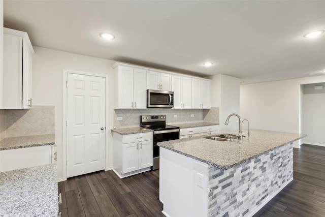 kitchen featuring white cabinetry, sink, an island with sink, and appliances with stainless steel finishes