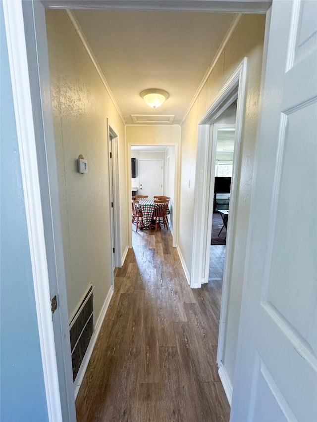 hall featuring crown molding and dark hardwood / wood-style floors