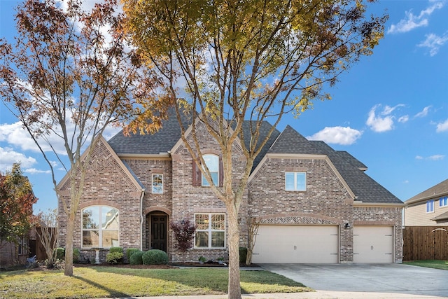 view of front of home featuring a garage and a front lawn