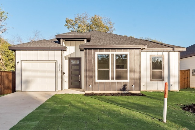 view of front of house with a front lawn and a garage