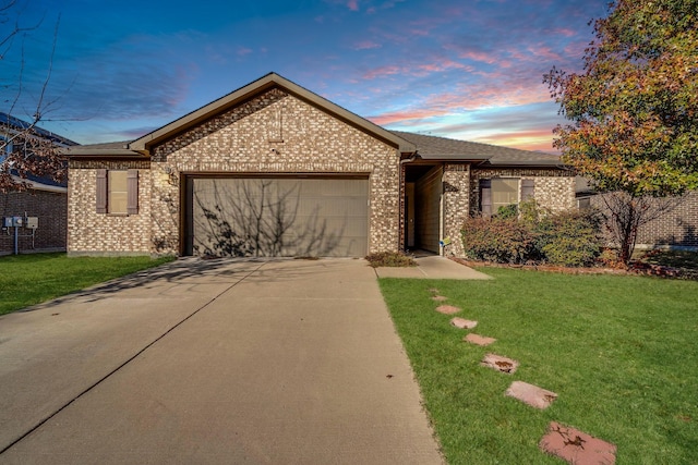 ranch-style house with a garage and a yard