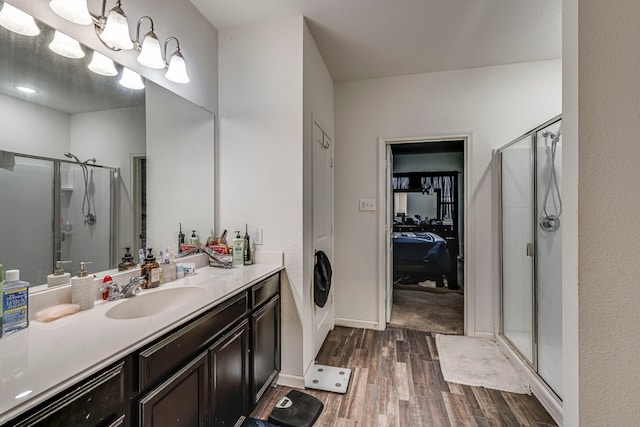 bathroom with vanity, hardwood / wood-style floors, and a shower with door