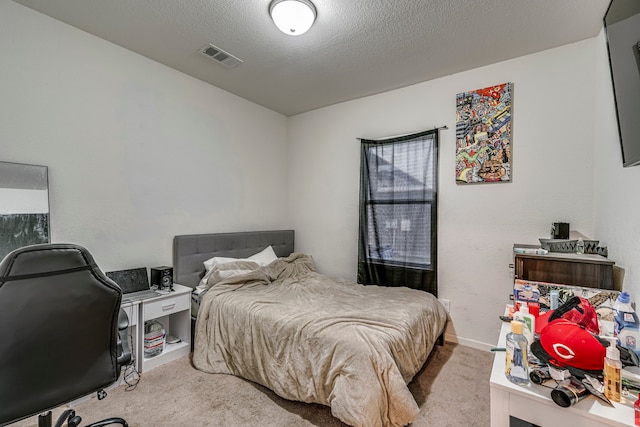 carpeted bedroom with a textured ceiling