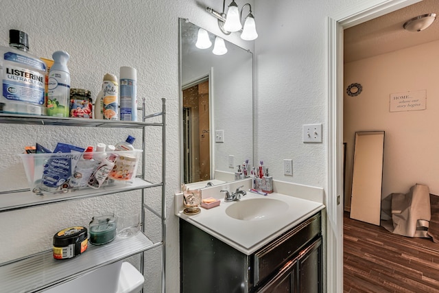 bathroom featuring toilet, vanity, and hardwood / wood-style floors