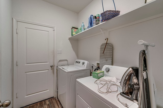 clothes washing area featuring washer and dryer and dark hardwood / wood-style floors