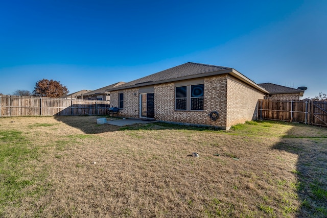 back of house featuring a yard and a patio