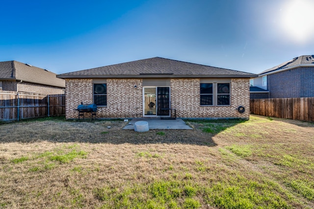 back of property featuring a lawn and a patio