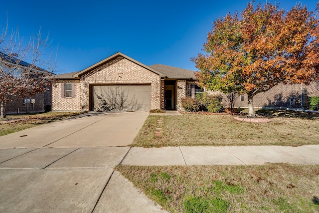 ranch-style home featuring a garage and a front yard