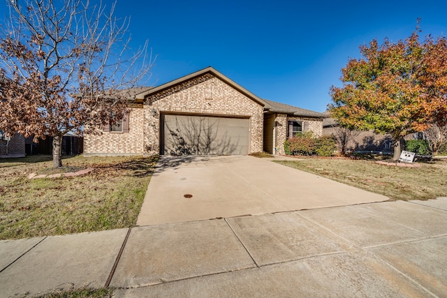 single story home with a garage and a front lawn