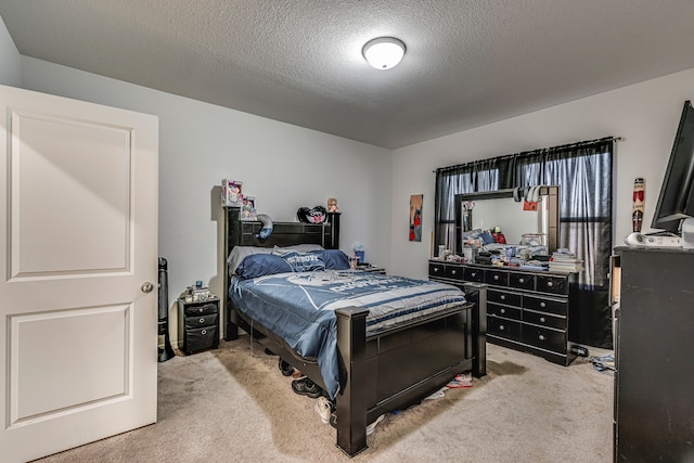 bedroom featuring light carpet and a textured ceiling