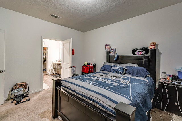 carpeted bedroom with a textured ceiling