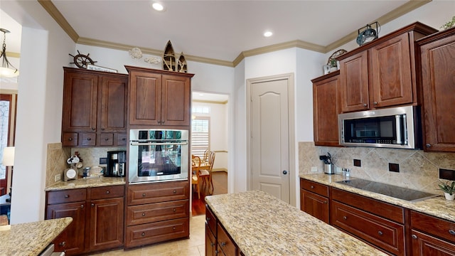 kitchen featuring light stone countertops, appliances with stainless steel finishes, hanging light fixtures, and crown molding