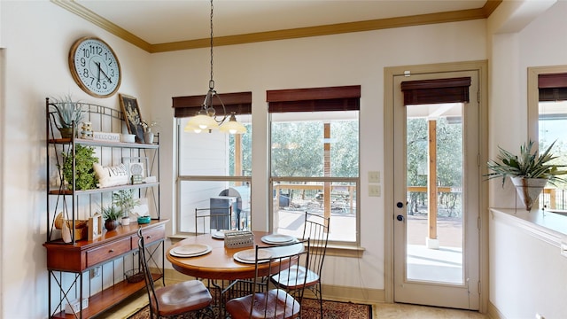 dining space with a chandelier and ornamental molding