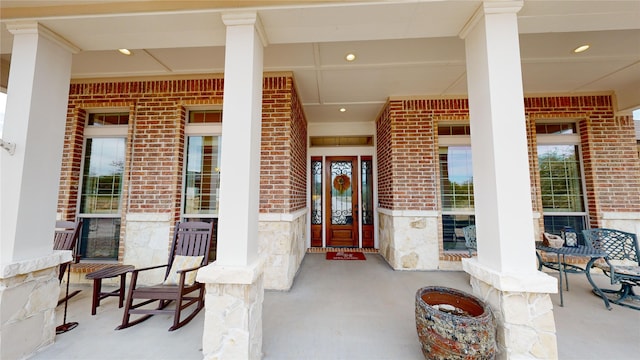 view of exterior entry featuring covered porch