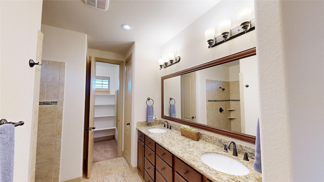 bathroom featuring vanity and tiled shower