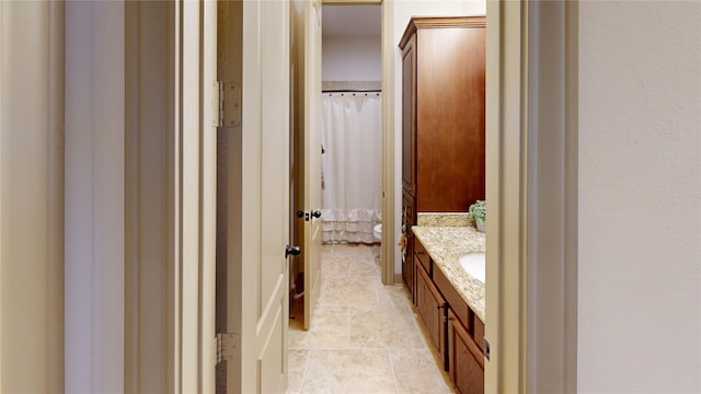 bathroom featuring tile patterned floors, vanity, and toilet