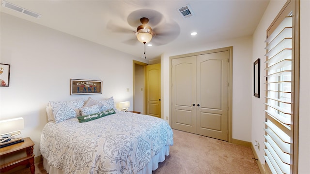 carpeted bedroom featuring a closet and ceiling fan