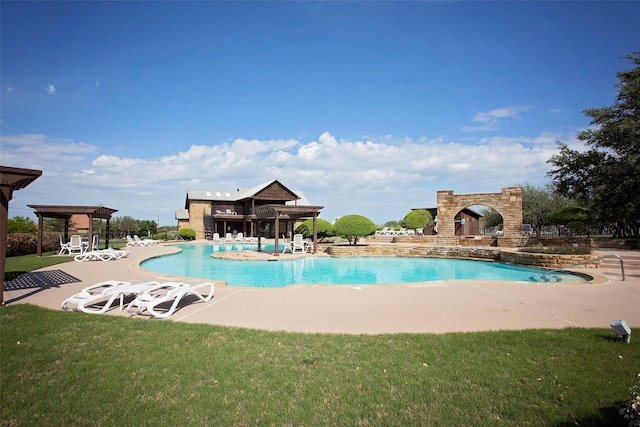 view of swimming pool featuring a lawn and a patio