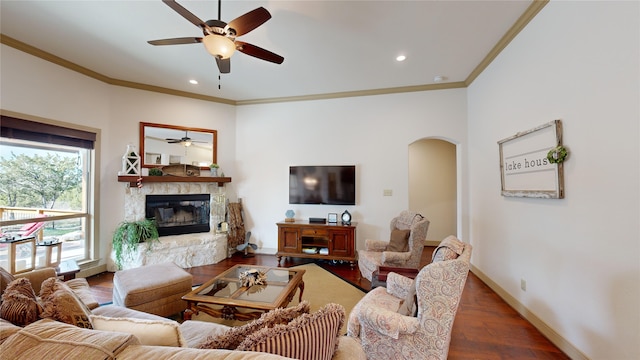 living room with ceiling fan, dark wood-type flooring, and ornamental molding