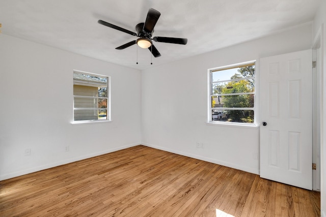 empty room with ceiling fan and light hardwood / wood-style floors