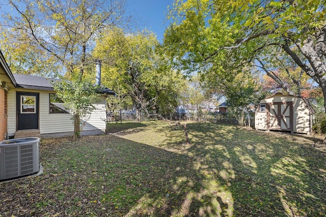 view of yard with a storage shed and central air condition unit