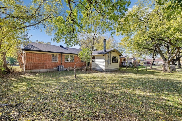 back of property with a yard and cooling unit