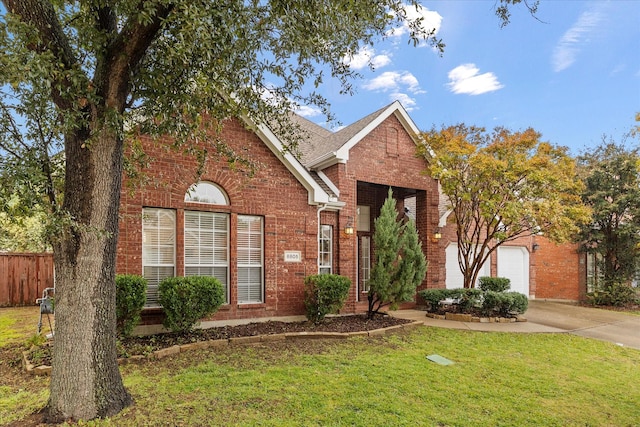 front of property with a front yard and a garage