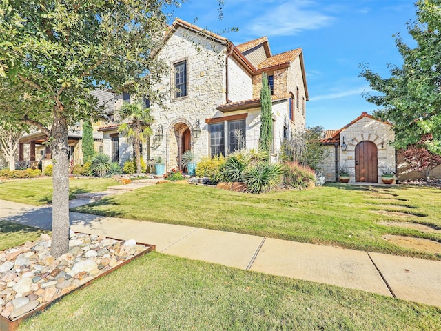 mediterranean / spanish house with a front yard