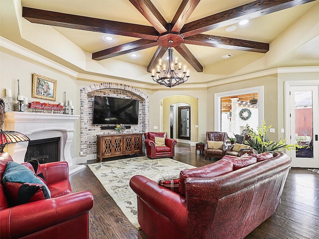 living room featuring beamed ceiling, dark hardwood / wood-style floors, ornamental molding, and a notable chandelier