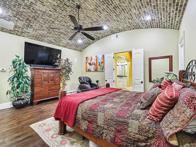 bedroom with connected bathroom, ceiling fan, high vaulted ceiling, dark hardwood / wood-style floors, and brick ceiling