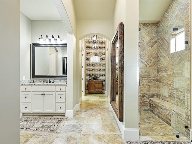 bathroom with vanity and a shower with door