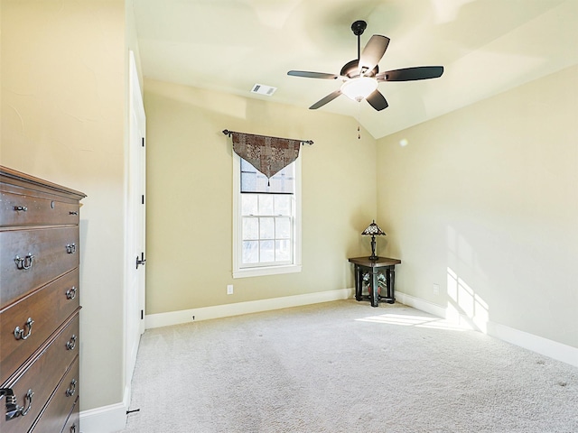 unfurnished room featuring ceiling fan, light colored carpet, and vaulted ceiling