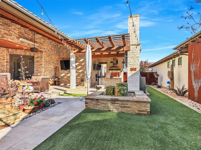 view of yard featuring a pergola, a patio, and exterior kitchen