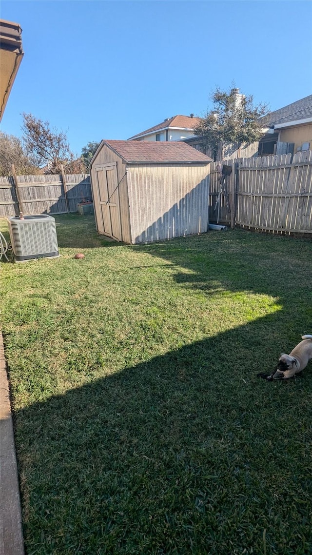 view of yard with cooling unit and a storage unit