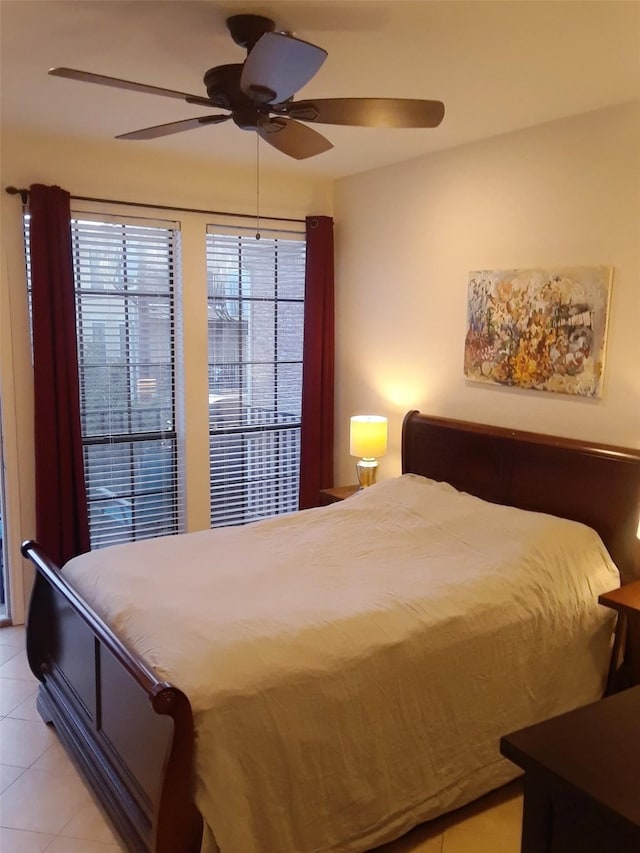 tiled bedroom featuring ceiling fan