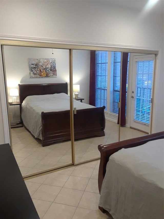 bedroom featuring light tile patterned floors and a closet