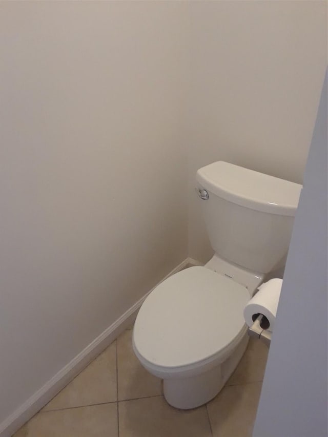 bathroom with tile patterned flooring and toilet