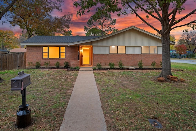 single story home with a lawn