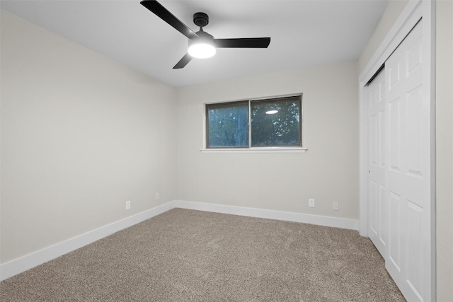 unfurnished bedroom with carpet flooring, ceiling fan, and a closet