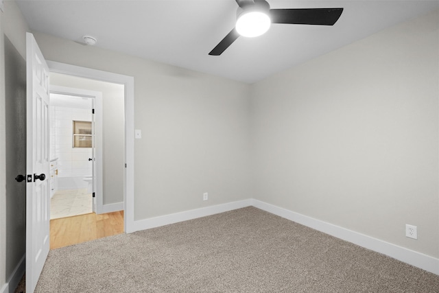 carpeted spare room with ceiling fan