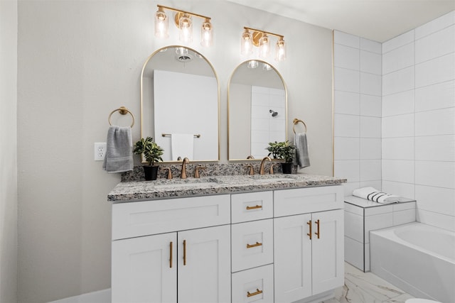 bathroom with a washtub and vanity