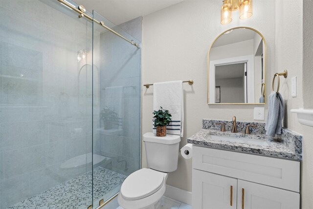 bathroom featuring an enclosed shower, vanity, and toilet