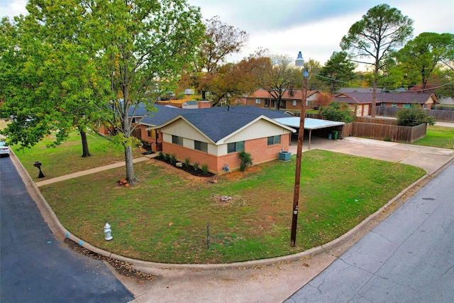 view of front of house featuring a carport and a front lawn