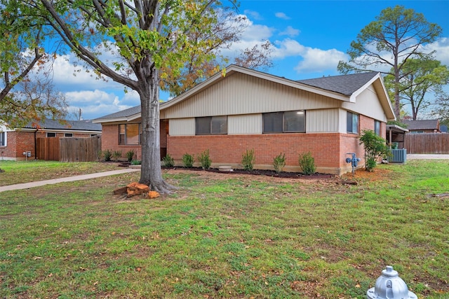 view of front of house with a front lawn and cooling unit