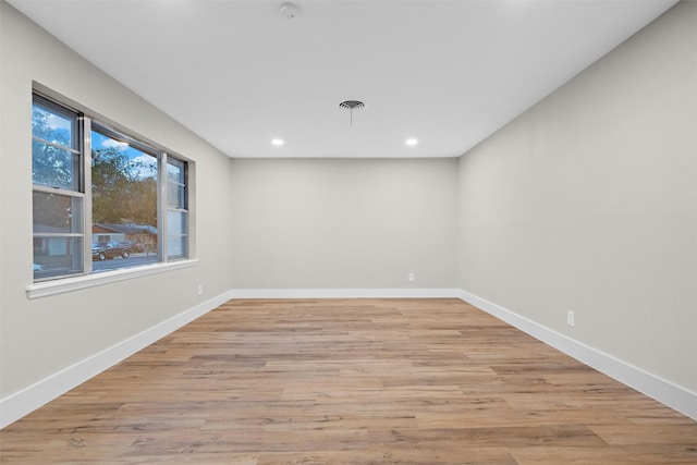 spare room featuring light hardwood / wood-style floors