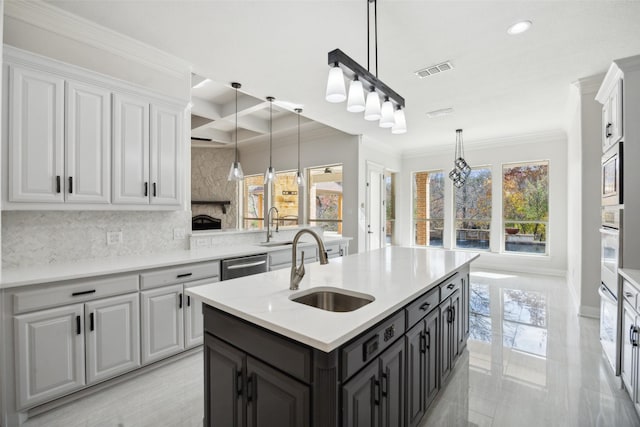 kitchen with visible vents, stainless steel dishwasher, white cabinetry, a sink, and built in microwave