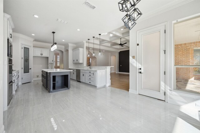 spare room featuring hardwood / wood-style floors, a tray ceiling, ceiling fan, and ornamental molding