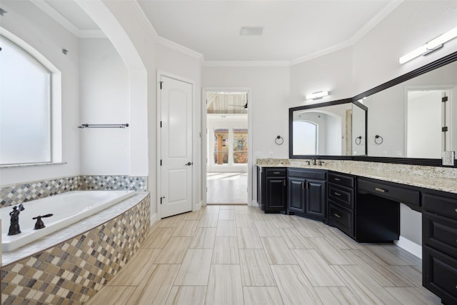 bathroom with crown molding, a bath, and vanity