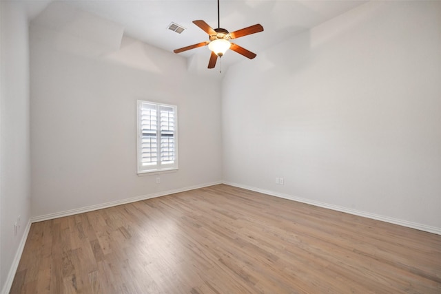 unfurnished room featuring ceiling fan, light hardwood / wood-style floors, and vaulted ceiling